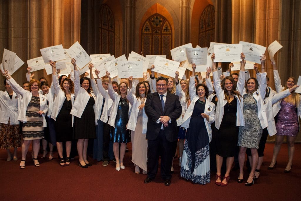Principal Robert Johnston stands with recent graduates of the Canadian Academy of Osteopathy